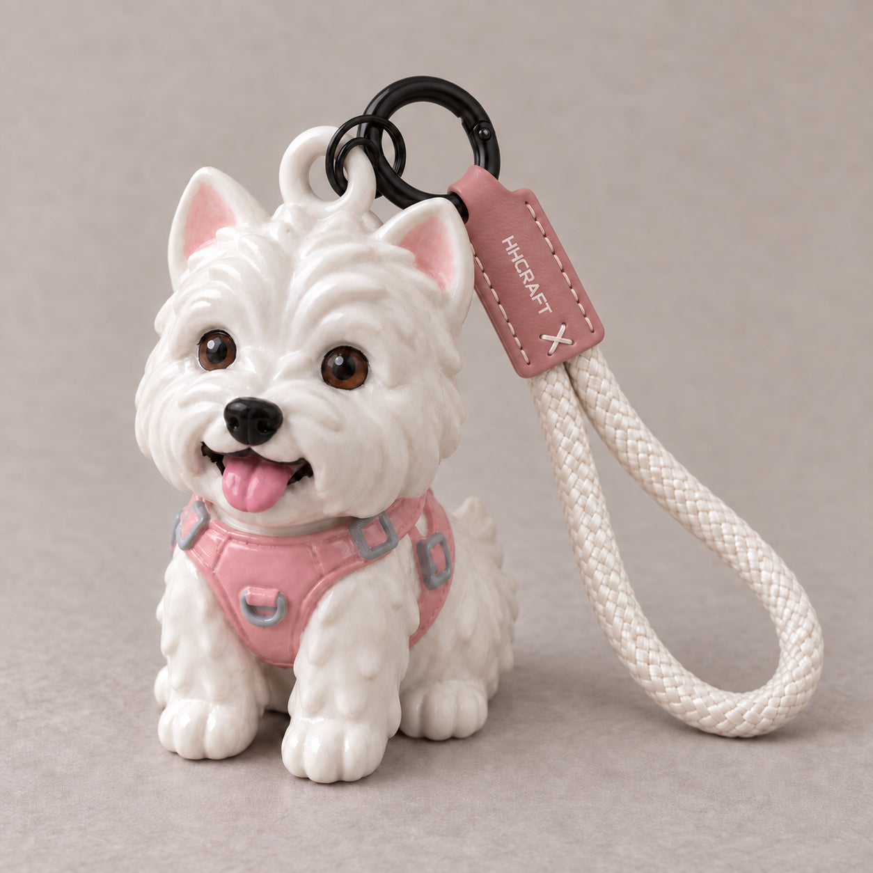 Illustrative Westie resin keychain with pink harness, molded head loop, black connector and braided wrist cord